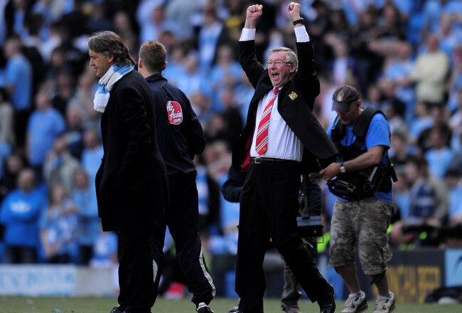 MANCHESTER, UNITED KINGDOM - APRIL 17:  Manchester United Manager Sir Alex Ferguson celebrates as Manchester City Manager Roberto Mancini looks on during the Barclays Premier League match between Manchester City and Manchester United at the City of Manchester Stadium on April 17, 2010 in Manchester, England. (Photo by Shaun Botterill/Getty Images)