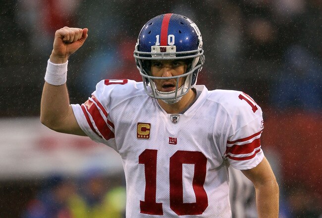 SAN FRANCISCO, CA - JANUARY 22:  Eli Manning #10 of the New York Giants celebrates after he threw a 6-yard touchdown pass to Bear Pascoe #86 against the San Francisco 49ers in the second quarter during the NFC Championship Game at Candlestick Park on January 22, 2012 in San Francisco, California.  (Photo by Jamie Squire/Getty Images)