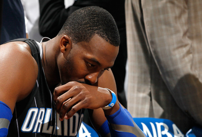 ATLANTA, GA - APRIL 28:  Dwight Howard #12 of the Orlando Magic sits on the bench during a timeout before the final seconds against the Atlanta Hawks during Game Six of the Eastern Conference Quarterfinals in the 2011 NBA Playoffs at Philips Arena on April 28, 2011 in Atlanta, Georgia.  NOTE TO USER: User expressly acknowledges and agrees that, by downloading and or using this photograph, User is consenting to the terms and conditions of the Getty Images License Agreement.  (Photo by Kevin C. Cox/Getty Images)
