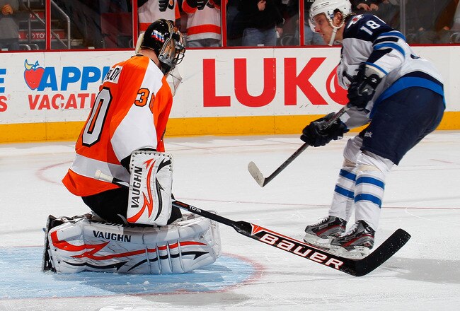PHILADELPHIA, PA - JANUARY 31:  Bryan Little #18 of the Winnipeg Jets shoots the puck past goalie Ilya Bryzgalov #30 of the Philadelphia Flyers for the winning goal during a shootout in an NHL hockey game at Wells Fargo Center on January 31, 2012 in Philadelphia, Pennsylvania.Jets won 2-1 in a shootout.  (Photo by Paul Bereswill/Getty Images)