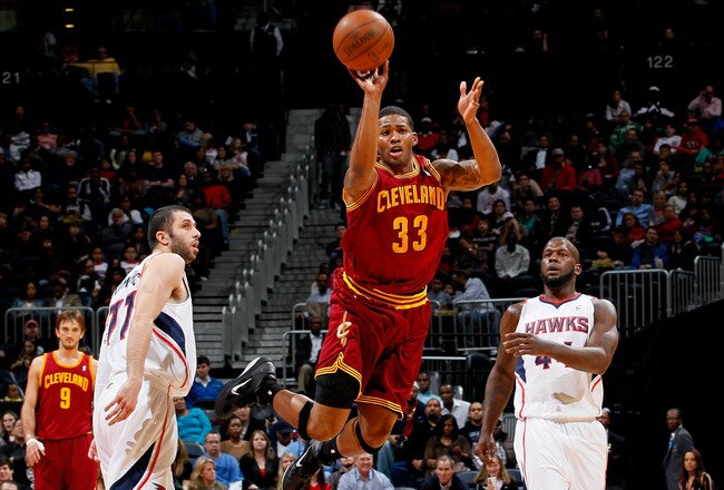 ATLANTA, GA - JANUARY 21:  Alonzo Gee #33 of the Cleveland Cavaliers attemps a halfcourt shot as time expires in the first half between Vladimir Radmanovic #77 and Ivan Johnson #44 of the Atlanta Hawks at Philips Arena on January 21, 2012 in Atlanta, Georgia.  NOTE TO USER: User expressly acknowledges and agrees that, by downloading and or using this photograph, User is consenting to the terms and conditions of the Getty Images License Agreement.  (Photo by Kevin C. Cox/Getty Images)