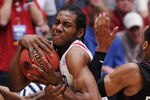 TUCSON, AZ - MARCH 19:  Ramone Moore #23 and Rahlir Jefferson #32 of the Temple Owls attempt to steal from Kawhi Leonard #15 of the San Diego State Aztecs in double overtime during the third round of the 2011 NCAA men's basketball tournament at McKale Center on March 19, 2011 in Tucson, Arizona.  (Photo by Harry How/Getty Images)
