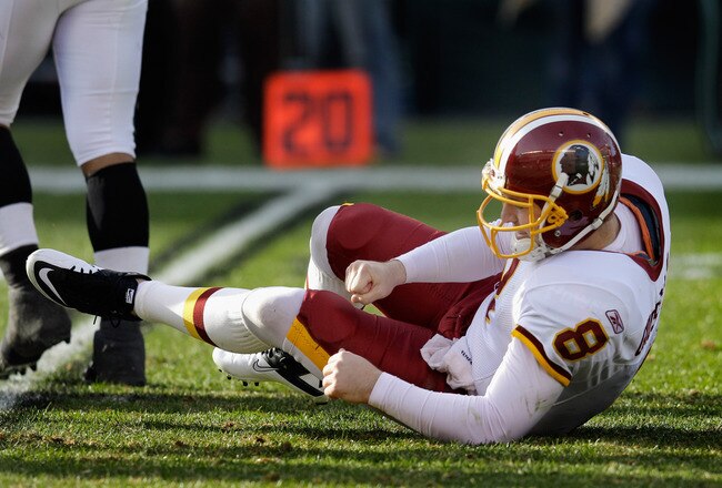 PHILADELPHIA, PA - JANUARY 01: Quarterback Rex Grossman #8 of the Washington Redskins gets up after being hit against the Philadelphia Eagles at Lincoln Financial Field on January 1, 2012 in Philadelphia, Pennsylvania.  (Photo by Rob Carr/Getty Images)