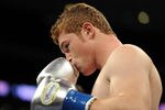LOS ANGELES, CA - SEPTEMBER 18:  Saul Alvarez of Mexico Carlos kisses his gloves before his match against Baldomir of Argentina in the WBC Super Welterweight Silver Title fight at Staples Center on September 18, 2010 in Los Angeles, California.  (Photo by Harry How/Getty Images)