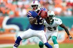 MIAMI GARDENS, FL - NOVEMBER 20:  Receiver Stevie Johnson #13 of the Buffalo Bills makes a catch in front of Cornerback Vontae Davis #21 of the Miami Dolphins at Sun Life Stadium on November 20, 2011 in Miami Gardens, Florida.  (Photo by Marc Serota/Getty Images)