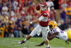 BATON ROUGE, LA - NOVEMBER 25:  Quarterback Tyler Wilson #8 of the Arkansas Razorbacks avoids a rush by defensive end Barkevious Mingo #49 of the LSU Tigers in the first quarter at Tiger Stadium on November 25, 2011 in Baton Rouge, Louisiana.  (Photo by Chris Graythen/Getty Images)
