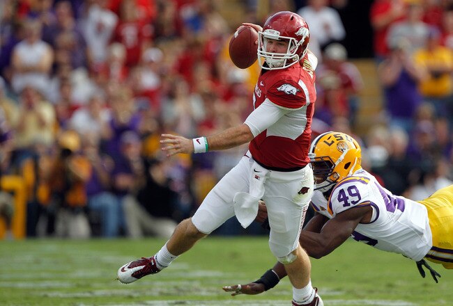 BATON ROUGE, LA - NOVEMBER 25:  Quarterback Tyler Wilson #8 of the Arkansas Razorbacks avoids a rush by defensive end Barkevious Mingo #49 of the LSU Tigers in the first quarter at Tiger Stadium on November 25, 2011 in Baton Rouge, Louisiana.  (Photo by Chris Graythen/Getty Images)