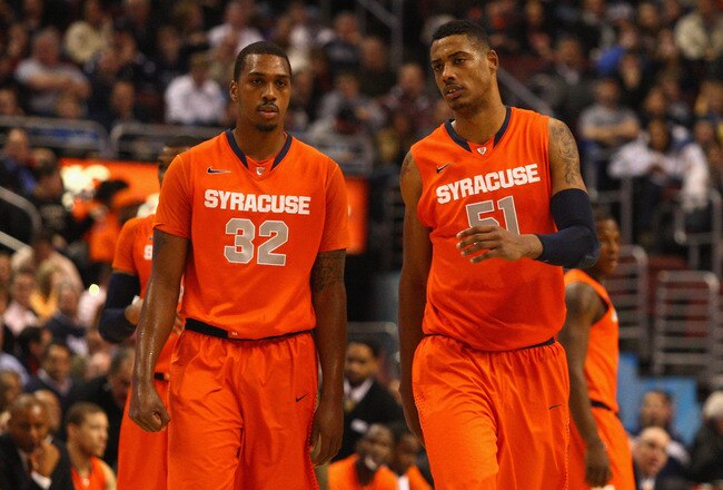 PHILADELPHIA, PA - JANUARY 11:  (L-R) Kris Joseph #32 and Fab Melo #51 of the Syracuse Orange talk as they walk on the court against the Villanova Wildcats at the Wells Fargo Center on January 11, 2012 in Philadelphia, Pennsylvania.  (Photo by Chris Chambers/Getty Images)