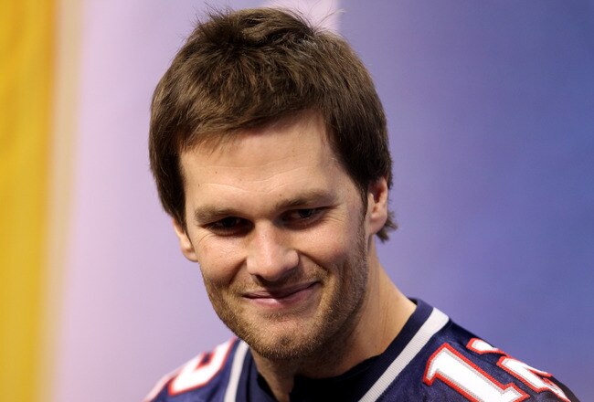 INDIANAPOLIS, IN - JANUARY 31:  Tom Brady #12 of the New England Patriotsanswers questions from the media during Media Day ahead of Super Bowl XLVI between against the New York Giants at Lucas Oil Stadium on January 31, 2012 in Indianapolis, Indiana.  (Photo by Andy Lyons/Getty Images)