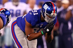 EAST RUTHERFORD, NJ - JANUARY 01:   Justin Tuck #91 and  Osi Umenyiora #72 of the New York Giants celebrate after a sack in the fourth quarter at MetLife Stadium on January 1, 2012 in East Rutherford, New Jersey.  (Photo by Al Bello/Getty Images)