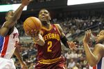 AUBURN HILLS, MI - DECEMBER 28:  Kyrie Irving #2 of the Cleveland Cavaliers gets a shot off between Rodney Stuckey #3 and Greg Monroe #10 of the Detroit Pistons on December 28, 2011 at the Palace of Auburn Hills in Auburn Hills, Michigan.  NOTE TO USER: User expressly acknowledges and agrees that, by downloading and or using this photograph, User is consenting to the terms and conditions of the Getty Images License Agreement. (Photo by Gregory Shamus/Getty Images)