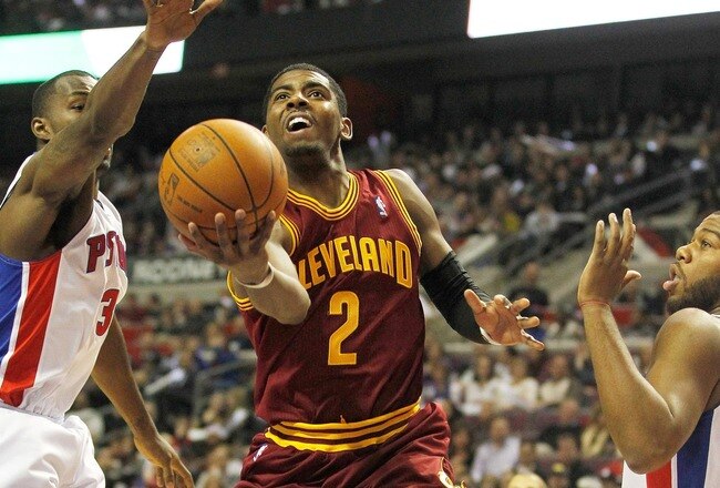 AUBURN HILLS, MI - DECEMBER 28:  Kyrie Irving #2 of the Cleveland Cavaliers gets a shot off between Rodney Stuckey #3 and Greg Monroe #10 of the Detroit Pistons on December 28, 2011 at the Palace of Auburn Hills in Auburn Hills, Michigan.  NOTE TO USER: User expressly acknowledges and agrees that, by downloading and or using this photograph, User is consenting to the terms and conditions of the Getty Images License Agreement. (Photo by Gregory Shamus/Getty Images)