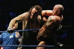 SYDNEY, AUSTRALIA - JUNE 15:  The Undertaker (L) pushes Bam Neely into the corner during WWE Smackdown at Acer Arena on June 15, 2008 in Sydney, Australia.  (Photo by Gaye Gerard/Getty Images)