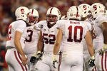 GLENDALE, AZ - JANUARY 02:  David DeCastro #52 of the Stanford Cardinal listens to Andrew Luck (L) #12 call a play in the huddle during the Tostitos Fiesta Bowl on January 2, 2012 at University of Phoenix Stadium in Glendale, Arizona.  (Photo by Donald Miralle/Getty Images)