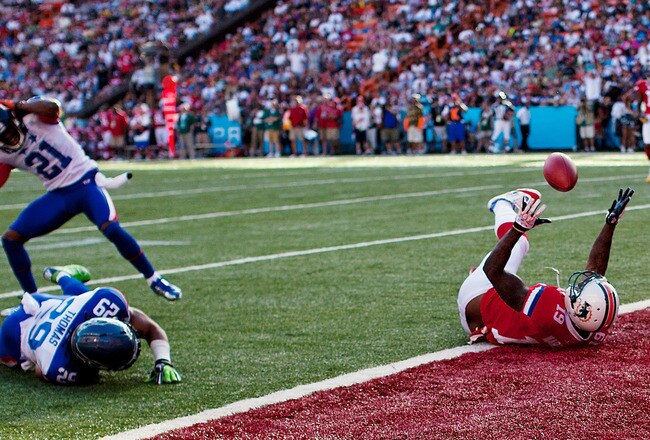 HONOLULU, HI - JANUARY 29:  Corey Graham #21 of the Chicago Bears reacts to Brandon Marshall #19 of the Miami Dolphins catching a loose ball in the endzone during the 2012 NFL Pro Bowl at Aloha Stadium on January 29, 2012 in Honolulu, Hawaii.  (Photo by Kent Nishimura/Getty Images)