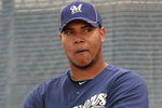 PHOENIX, AZ - FEBRUARY 18:  Pitcher Wily Peralta #73 of the Milwaukee Brewers listens to coaches during a MLB spring training practice at Maryvale Baseball Park on February 18, 2011 in Phoenix, Arizona.  (Photo by Christian Petersen/Getty Images)