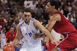 ATHENS - AUGUST 23:  Dimosthenis Ntikoudis of Greece attacks the ball in front of Peter John Ramos of Puerto Rico in the men's basketball preliminary game between Greece and Puerto Rico on August 23, 2004 during the Athens 2004 Summer Olympic Games at the Indoor Arena of the Helliniko Olympic Complex in Athens, Greece. (Photo by Stuart Hannagan/Getty Images)