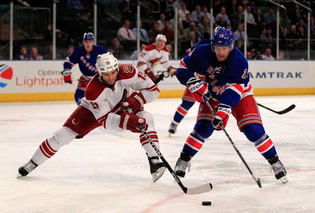 NEW YORK, NY - JANUARY 10: (L) Boyd Gordon #15 of the Phoenix Coyotes skates against (R) Marc Staal #18 of the New York Rangers at Madison Square Garden on January 10, 2012 in New York City.  (Photo by Chris Trotman/Getty Images)