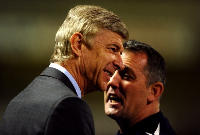 BOLTON, ENGLAND - FEBRUARY 01:   Bolton Wanderers Manager Owen Coyle (R) speaks to Arsenal Manager Arsene Wenger prior to the Barclays Premier League match between Bolton Wanderers and Arsenal at the Reebok Stadium on February 1, 2012 in Bolton, England. (Photo by Laurence Griffiths/Getty Images)
