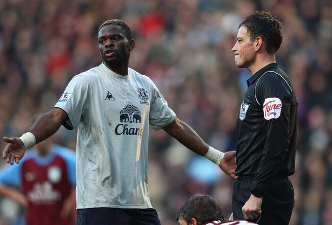 BIRMINGHAM, ENGLAND - JANUARY 14:  Louis Saha of Everton talks with referee Mark Clattenburg during the Barclays Premier League match between Aston Villa and Everton at Villa Park on January 14, 2012 in Birmingham, England.  (Photo by Clive Mason/Getty Images)
