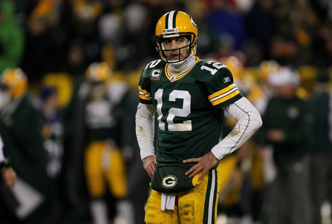 GREEN BAY, WI - JANUARY 15:  Aaron Rodgers #12 of the Green Bay Packers looks on in the third quarter against the New York Giants during their NFC Divisional playoff game at Lambeau Field on January 15, 2012 in Green Bay, Wisconsin.  (Photo by Jonathan Daniel/Getty Images)