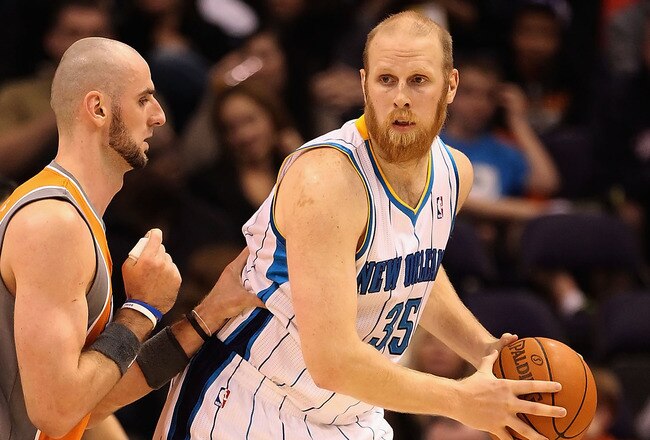 PHOENIX, AZ - DECEMBER 26:  Chris Kaman #35 of the New Orleans Hornets handles the ball during the season openning NBA game against the Phoenix Suns at US Airways Center on December 26, 2011 in Phoenix, Arizona.  The Hornets defeated the Suns 85-84. NOTE TO USER: User expressly acknowledges and agrees that, by downloading and or using this photograph, User is consenting to the terms and conditions of the Getty Images License Agreement.  (Photo by Christian Petersen/Getty Images)