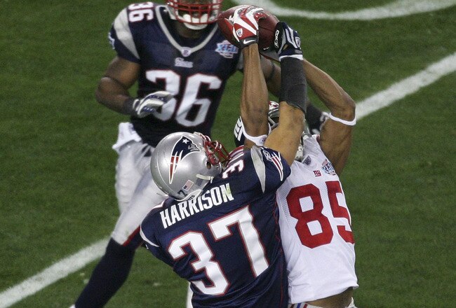 GLENDALE, AZ - FEBRUARY 03:  David Tyree #85 of the New York Giants catches a 32-yard pass from Eli Manning #10 as Rodney Harrison #37 of the New England Patriots attempts to knock it out in the fourth quarter of Super Bowl XLII on February 3, 2008 at the University of Phoenix Stadium in Glendale, Arizona.  (Photo by Jim McIsaac/Getty Images)