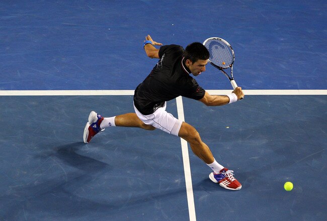 MELBOURNE, AUSTRALIA - JANUARY 29:  Novak Djokovic of Serbia plays a backhand in his men's final match against Rafael Nadal of Spain during day fourteen of the 2012 Australian Open at Melbourne Park on January 29, 2012 in Melbourne, Australia.  (Photo by Cameron Spencer/Getty Images)