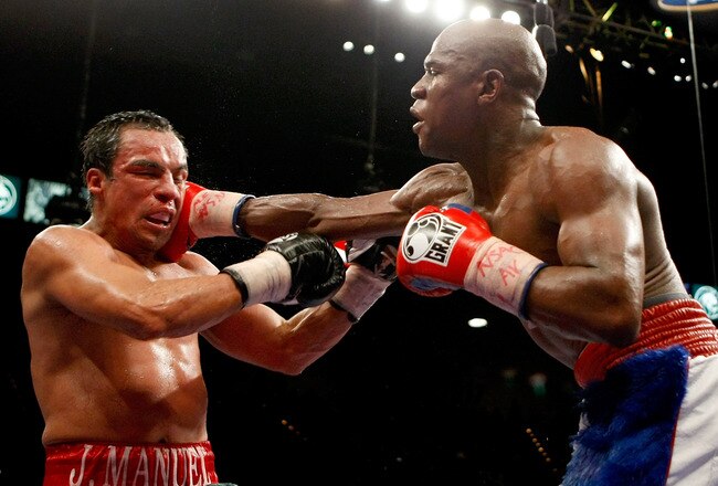 LAS VEGAS - SEPTEMBER 19:  Floyd Mayweather Jr. (R) hits Juan Manuel Marquez in the 11th round of their fight at the MGM Grand Garden Arena September 19, 2009 in Las Vegas, Nevada. Mayweather won by unanimous decision.  (Photo by Ethan Miller/Getty Images)