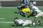 ANN ARBOR, MI - SEPTEMBER 7:  Braylon Edwards #80 of the University of Michigan Wolverines loses the ball after being hit by Sam Reynolds #41 and Scott Robinson #25 of the Western Michigan Broncos in the first half on September 7, 2002 at Michigan Stadium in Ann Arbor, Michigan.  The ball bounced out of bounds and Michigan held possesion. Michigan defeated Western Michigan 35-12.   (Photo by Danny Moloshok/Getty Images).