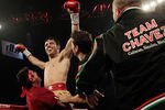 HOUSTON - NOVEMBER 19:  Julio Chavez Jr. is lifted up by his corner after stopping Peter Manredo Jr. with TKO in the fifth round to retain his World Middleweight  Championship at Reliant Arena at Reliant Park on November 19, 2011 in Houston, Texas.  (Photo by Bob Levey/Getty Images)