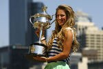 MELBOURNE, AUSTRALIA - JANUARY 29:  Victoria Azarenka of Belarus poses with the Daphne Akhurst Trophy after winning the 2012 Women's Australian Open final, along the Yarra River on January 29, 2012 in Melbourne, Australia.  (Photo by Robert Prezioso/Getty Images)