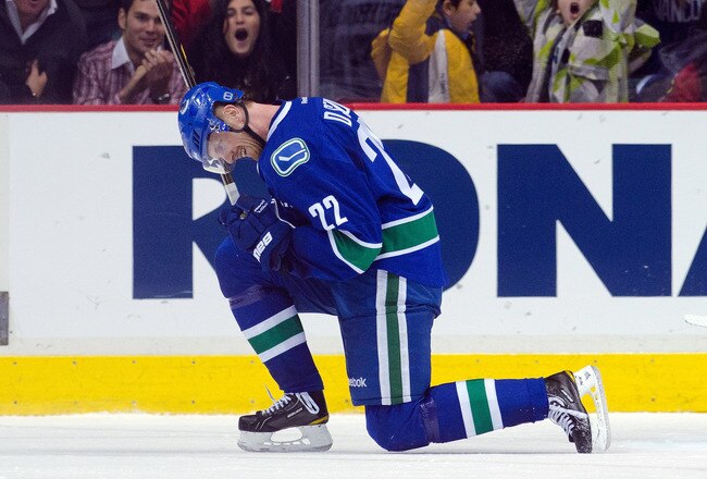 VANCOUVER, CANADA - JANUARY 31: Daniel Sedin #22 of the Vancouver Canucks celebrates with Sami Salo #6 after scoring a goal to defeat the Chicago Blackhawks 3-2 in overtime during NHL action on January 31, 2012 at Rogers Arena in Vancouver, British Columbia, Canada.  (Photo by Rich Lam/Getty Images)