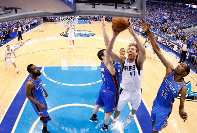 DALLAS, TX - MAY 25:  Dirk Nowitzki #41 of the Dallas Mavericks goes up for a shot between Nick Collison #4 and Kevin Durant #35 of the Oklahoma City Thunder in the second half in Game Five of the Western Conference Finals during the 2011 NBA Playoffs at American Airlines Center on May 25, 2011 in Dallas, Texas. NOTE TO USER: User expressly acknowledges and agrees that, by downloading and or using this photograph, User is consenting to the terms and conditions of the Getty Images License Agreement.  (Photo by Ronald Martinez/Getty Images)