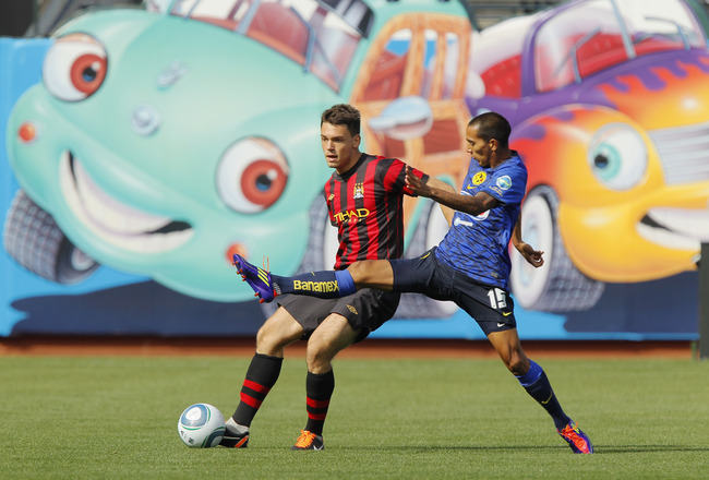 SAN FRANCISCO, CA - JULY 16:  Frederic Veseli #56 of Manchester City moves to work around Edgar Castillo #15 of Club America at AT&T Park on July 16, 2011 in San Francisco, California.  Manchester City led 2-0 at the half.  (Photo by Brian Bahr/Getty Images)