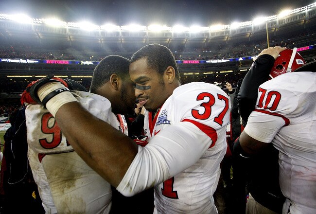 NEW YORK - DECEMBER 30:  (L-R) Jamil Merrell #92 and Jamal Merrell #37 of the Rutgers Scarlet Knights celebrate a win over the Iowa State Cyclones in the New Era Pinstripe Bowl at Yankee Stadium on December 30, 2011 in the Bronx Borough of New York City.  (Photo by Jeff Zelevansky/Getty Images)