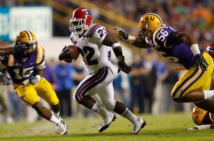 BATON ROUGE, LA - NOVEMBER 14:  Tyrone Duplessis #22 of the Louisiana Tech Bulldogs is brought down by Perry Riley #56 of the LSU Tigers at Tiger Stadium on November 14, 2009 in Baton Rouge, Louisiana.  (Photo by Chris Graythen/Getty Images)