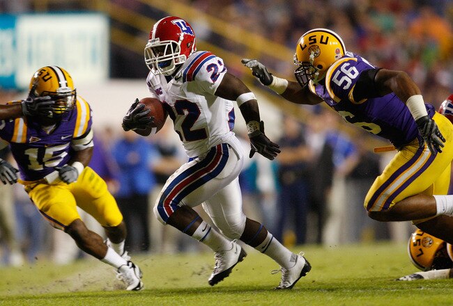 BATON ROUGE, LA - NOVEMBER 14:  Tyrone Duplessis #22 of the Louisiana Tech Bulldogs is brought down by Perry Riley #56 of the LSU Tigers at Tiger Stadium on November 14, 2009 in Baton Rouge, Louisiana.  (Photo by Chris Graythen/Getty Images)
