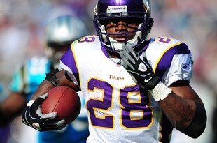 CHARLOTTE, NC - OCTOBER 30: Adrian Peterson #28 of the Minnesota Vikings runs with a catch for a touchdown against the Carolina Panthers at Bank of America Stadium on October 30, 2011 in Charlotte, North Carolina. (Photo by Scott Cunningham/Getty Images)