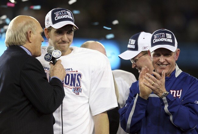GLENDALE, AZ - FEBRUARY 03:  Fox sports analyst Terry Bradshaw (L) interviews quarterback Eli Manning #10 of the New York Giants as head coach Tom Coughlin celebrates after the Giants defeated the New England Patriots 17-14 during Super Bowl XLII on February 3, 2008 at the University of Phoenix Stadium in Glendale, Arizona.  (Photo by Elsa/Getty Images)