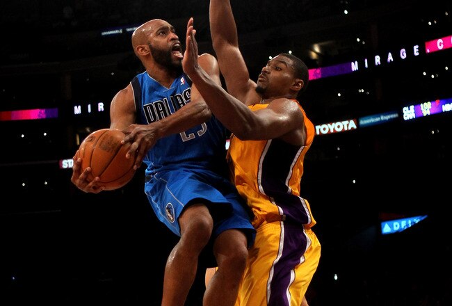 LOS ANGELES, CA - JANUARY 16: Vince Carter #25 of the Dallas Mavericks goes up and scores over Andrew Bynum #17 of the Los Angeles Lakers at Staples Center on January 16, 2012 in Los Angeles, California. The Lakers won 73-70.  NOTE TO USER: User expressly acknowledges and agrees that, by downloading and or using this photograph, User is consenting to the terms and conditions of the Getty Images License Agreement.  (Photo by Stephen Dunn/Getty Images)