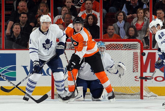 PHILADELPHIA - MARCH 07:  Luke Schenn #2, Jean-Sebastien Giguere #35, and Tyler Bozak #42 of the Toronto Maple Leafs defend against James van Riemsdyk #21 of the Philadelphia Flyers on March 7, 2010 at Wachovia Center in Philadelphia, Pennsylvania. The Flyers defeated the Leafs 3-1.  (Photo by Jim McIsaac/Getty Images)