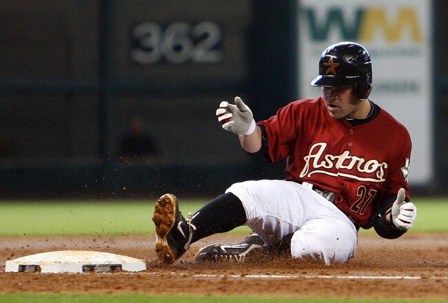 HOUSTON - SEPTEMBER 25:  Jose Altuve #27 of the Houston Astros slides into third base after a single was misplayed by centerfielder Eric Young Jr. #1 of the Colorado Rockies in the third inning at Minute Maid Park on September 25, 2011 in Houston, Texas. Colorado won 19-2.  (Photo by Bob Levey/Getty Images)