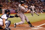 ST PETERSBURG, FL - SEPTEMBER 28:  Mark Teixeira #25 of the New York Yankees hits a grand slam home run in the second inning against the Tampa Bay Rays during the game at Tropicana Field on September 28, 2011 in St. Petersburg, Florida.  (Photo by J. Meric/Getty Images)