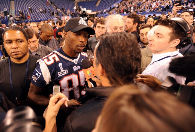 INDIANAPOLIS, IN - JANUARY 31:  Chad Ochocinco #85 of the New England Patriots answers questions from the media during Media Day ahead of Super Bowl XLVI against the New York Giants at Lucas Oil Stadium on January 31, 2012 in Indianapolis, Indiana.  (Photo by Michael Heiman/Getty Images)