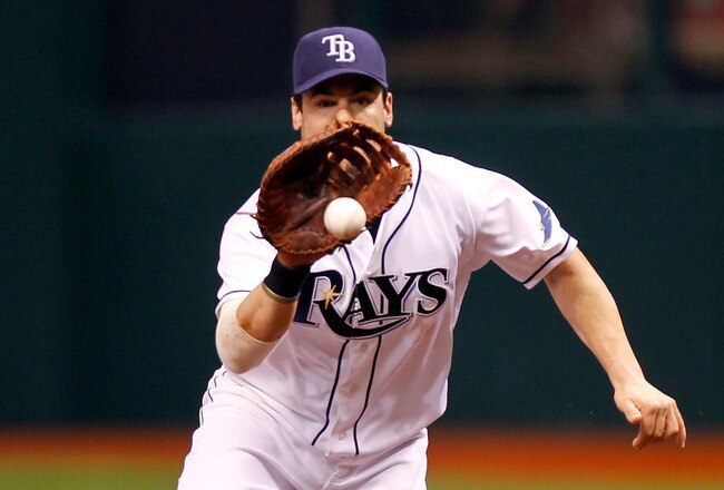 ST PETERSBURG, FL - OCTOBER 03:  First baseman Casey Kotchman #11 of the Tampa Bay Rays fields a ground ball hit by Mitch Moreland #18 of the Texas Rangers and steps on first base for the out in the second inning in Game Three of the American League Division Series at Tropicana Field on October 3, 2011 in St Petersburg, Florida.  (Photo by Mike Ehrmann/Getty Images)