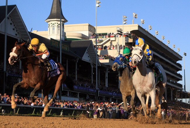 LOUISVILLE, KY - NOVEMBER 05:  Jockey Ramon Dominguez rides Hansen #5, far right, ahead of jockey Javier Castellano and Union Rags #10 to win the Breeders' Cup Juvenile during the 2011 Breeders' Cup World Championships at Churchill Downs on November 5, 2011 in Louisville, Kentucky.  (Photo by Rob Carr/Getty Images)