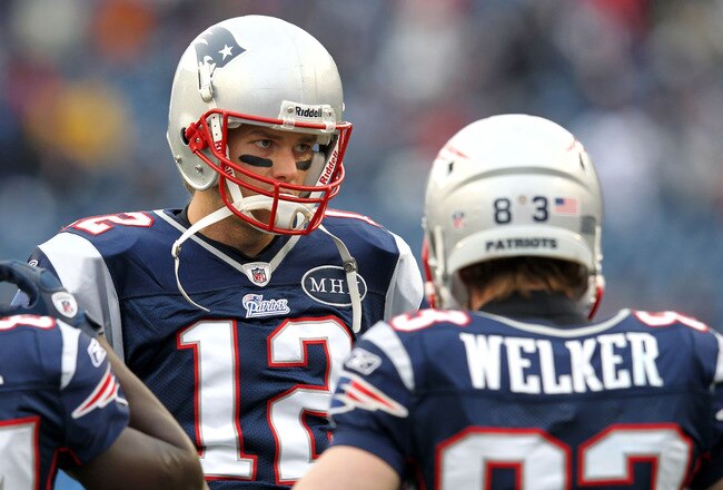 FOXBORO, MA - JANUARY 22:  Tom Brady #12 of the New England Patriots talks with teammate Wes Welker #83 against the Baltimore Ravens during their AFC Championship Game at Gillette Stadium on January 22, 2012 in Foxboro, Massachusetts.  (Photo by Jim Rogash/Getty Images)