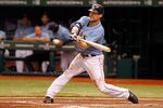 ST PETERSBURG, FL - OCTOBER 04:  Casey Kotchman #11 of the Tampa Bay Rays hits a RBI single in the fourth inning score Sean Rodriguez #1 against the Texas Rangers in Game Four of the American League Division Series at Tropicana Field on October 4, 2011 in St Petersburg, Florida.  (Photo by Mike Ehrmann/Getty Images)