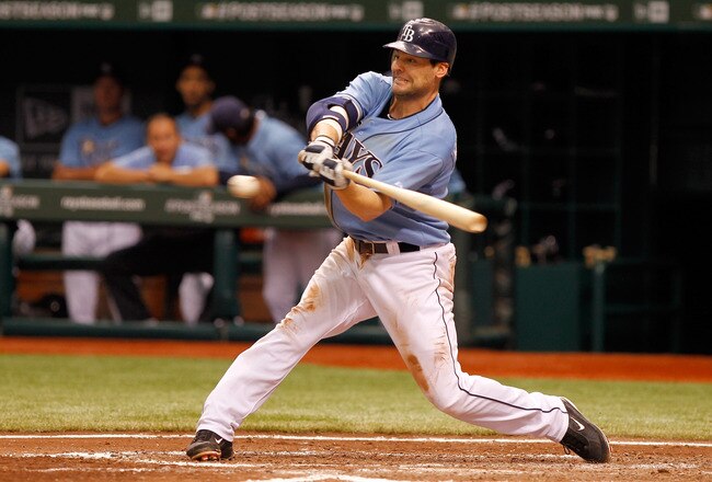 ST PETERSBURG, FL - OCTOBER 04:  Casey Kotchman #11 of the Tampa Bay Rays hits a RBI single in the fourth inning score Sean Rodriguez #1 against the Texas Rangers in Game Four of the American League Division Series at Tropicana Field on October 4, 2011 in St Petersburg, Florida.  (Photo by Mike Ehrmann/Getty Images)